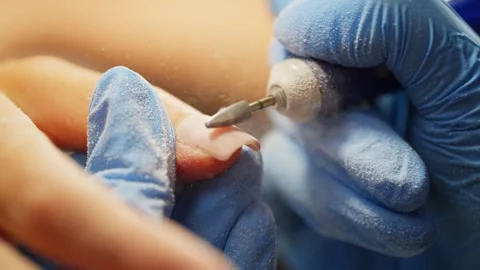 Professional nail master treating and cleaning female fingernails Video stock 343538658