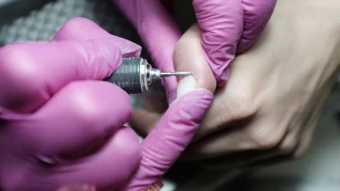 Professional nail technician removing cuticle with professional electric drill.  Stock Footage 326252205