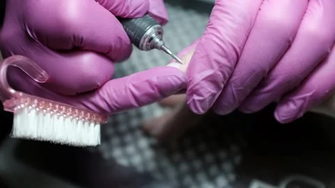 Professional nail technician removing cuticle with professional electric drill.  Stock Footage 326252503