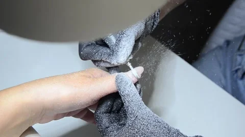Professional nail technician removing old gel polish with an electric nail drill Stock Footage 340143235