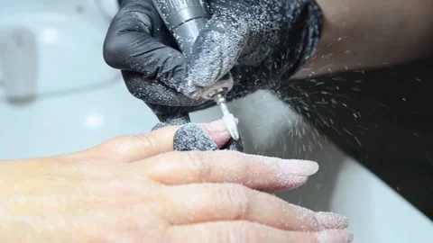 Professional nail technician removing old gel polish with an electric nail drill Video stock 340143242