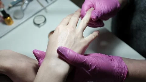 Professional nail technician using candle wax for hand massage after performing  Stock Footage 326252046