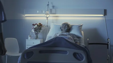 Professional nurse checking a senior patient at night Stock Footage 127595866