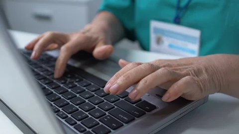 Professional nurse working on laptop, checking patient examination results Vídeo Stock 118907213