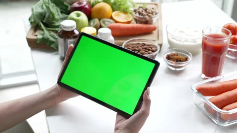 Professional Nutritionist checking data from a tablet with green screen Stock Footage 241758455