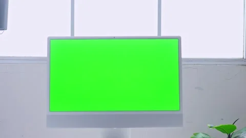 Professional office setup with green screen monitor on white desk against window Stock Footage 328553350