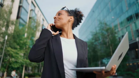 Professional office worker with laptop and mobile phone in city street, portrait Stock Footage 344391044