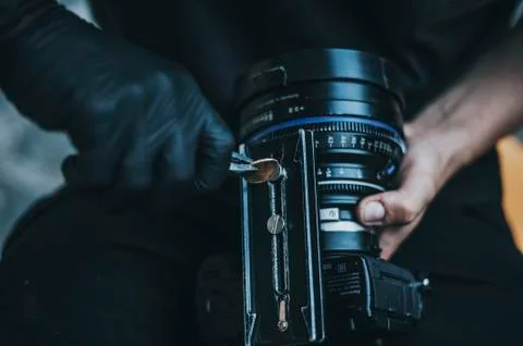 Professional operator fix camera holder close shoot Stock Photos