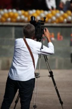 Professional operator with a video camera at work. Stock Photos