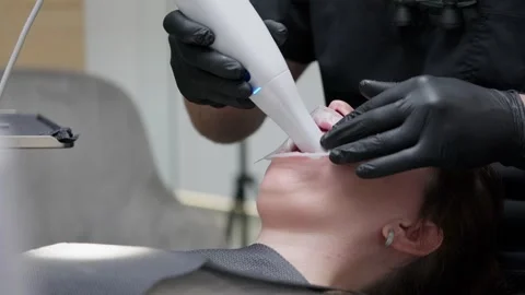 Professional orthodontist in black gloves using a modern 3d intraoral scanner Stock Footage 339273994
