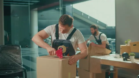 Professional Packing and Unpacking Services. Packing and Preparation for Moving Stock Footage 236309953