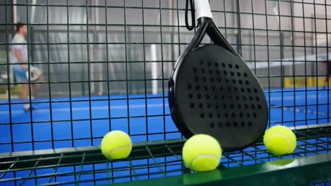 Professional paddle racket in focus and players at background. Stock Footage 346635762