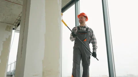 Professional painter applying white paint on walls in new building Stock-Footage 314557155