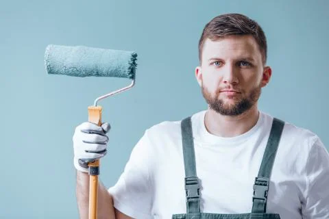 Professional painter with blue roller 库存照片