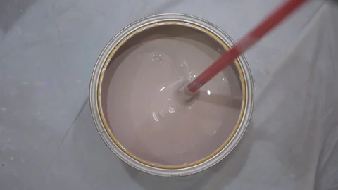 Professional painter mixes paint with red nozzle on drill Stock Footage 124003423