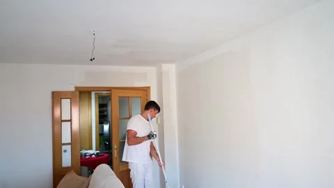 Professional painter renovating apartment ceiling with a roller 스톡 동영상 341362837