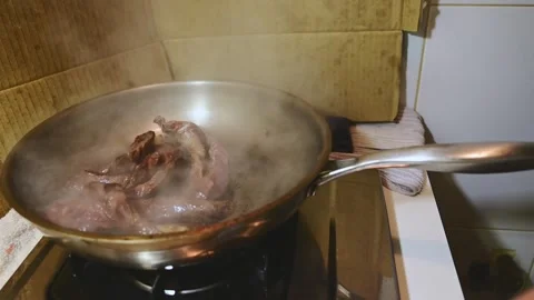 Professional Pan Tossing Beef Strips with Rising Flames and Smoke Stock Footage 344670590
