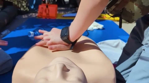A professional paramedic teacher is teaching a boy first aid and CPR training fo Stock Footage 339766020