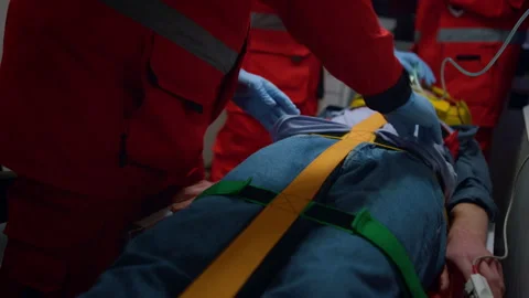Professional paramedics performing first aid procedure in emergency car Stock Footage 166883989