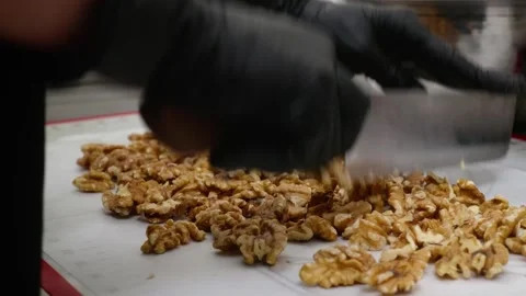 Professional Pastry Chef Chopping Fresh Walnuts for Homemade Dessert Pie on Whit Stock Footage 337751555