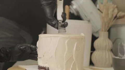 Professional pastry chef decorating a cake with a chocolate icing Stock Footage 287075822