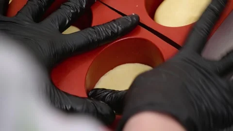 Professional Pastry Chef Hands in Black Gloves Pressing Dough into Red Silicone Stock Footage 337751571
