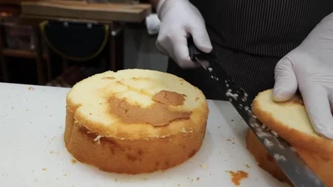 Professional Pastry Chef Leveling and Slicing Freshly Baked Sponge Cake Stock Footage 331777853