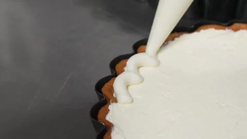 Professional Pastry Chef Piping White Cream Swirls on a Gourmet Dessert Tart Stock Footage 337751184