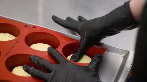 Professional Pastry Chef Pressing Dough into Silicone Molds for Mini Dessert Pie Stock Footage 337751568