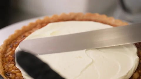 Professional Pastry Chef Spreading Smooth White Cream on a Golden Tart Crust Stock Footage 337751510