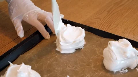 Professional Pastry Chef Spreading White Meringue Mixture on Baking Sheet Stock Footage 331780916