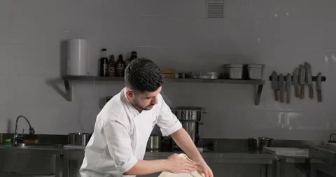 Professional pastry chef stretches phyllo dough to prepare traditional Turkish Stock Footage 288506854