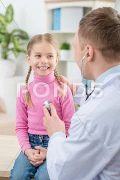Professional Pediatrician Examining Little Girl