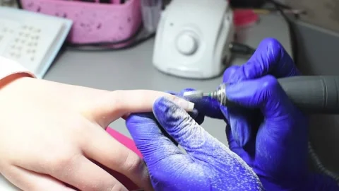 Professional pedicure master files nails , preparation for polishing with Stock Footage 236653896