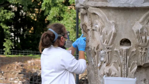 Professional performance of cleaning the carving on monument by an archeologist Stock Footage 144820815