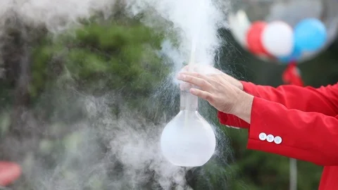 Professional performer shows trick with liquid nitrogen slow Stock Footage 117919198
