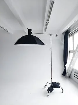 Professional photo flash light with a big softbox on a c-stand on a cyclorama in Stock Photos