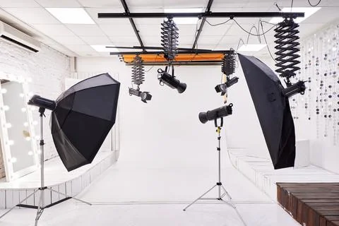 Professional Photo Studio Interior with Lighting Equipment and White Backdrop Stock Photos