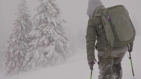 Professional photographer with backpack during severe snow storm Stock Footage 146369518