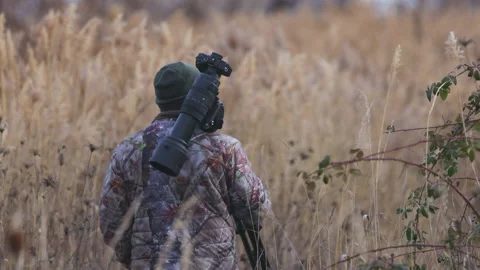 Wildlife photographer in the ghillie suit working Stock Photo | Adobe Stock