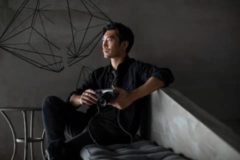 Professional photographer with digital camera in studio Stock Photos
