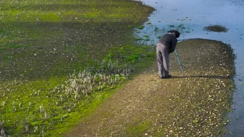 A Professional Photographer Using Tripod Camera Stock Footage 265441339