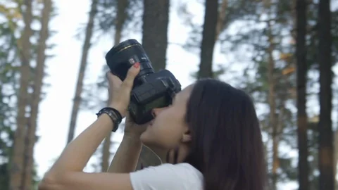 Professional photographer while working outdoors in summer forest. Caucasian 스톡 동영상 129861552