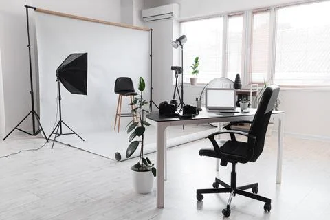 Professional photography studio interior with white backdrop, lighting equipm Stock Photos