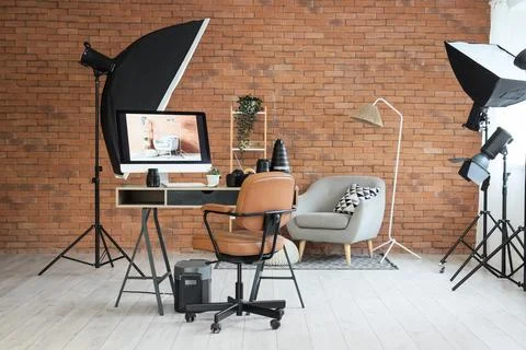 Professional photography studio setup with computer monitor displaying interi Stock Photos