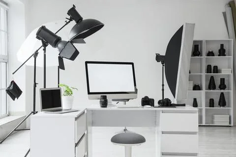 Professional photography studio setup with desktop computer, laptop, cameras, Stock Photos