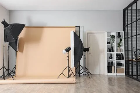 Professional photography studio setup with softboxes, strobe lights, and pape Stock Photos