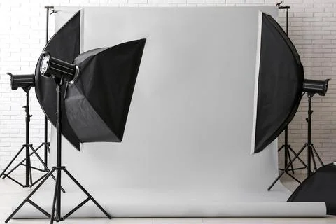 Professional photography studio setup with softboxes and white backdrop for c Stock Photos