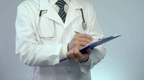 Professional physician writing in paper documents, keeping medical records Video stock 64798688