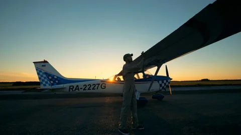 Professional pilot checks wings of a plane. A man looks at wing, checking them Stock Footage 95487564